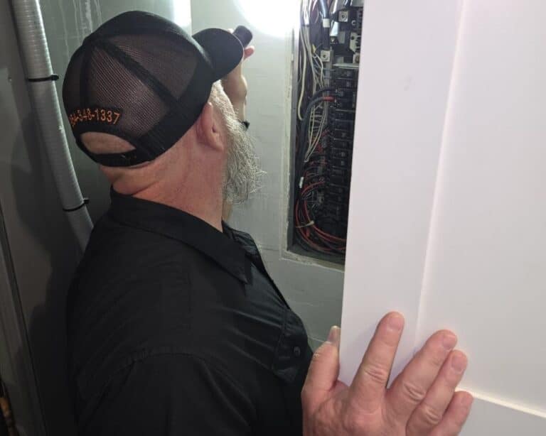 Steve from Absolute Property Inspections checking electrical panel